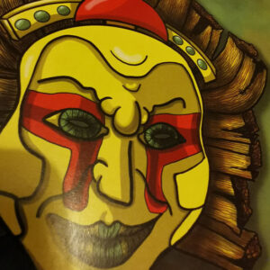 Zoom sur le masque doré inspiré du dieu soleil maya, détails rouges sur les yeux.