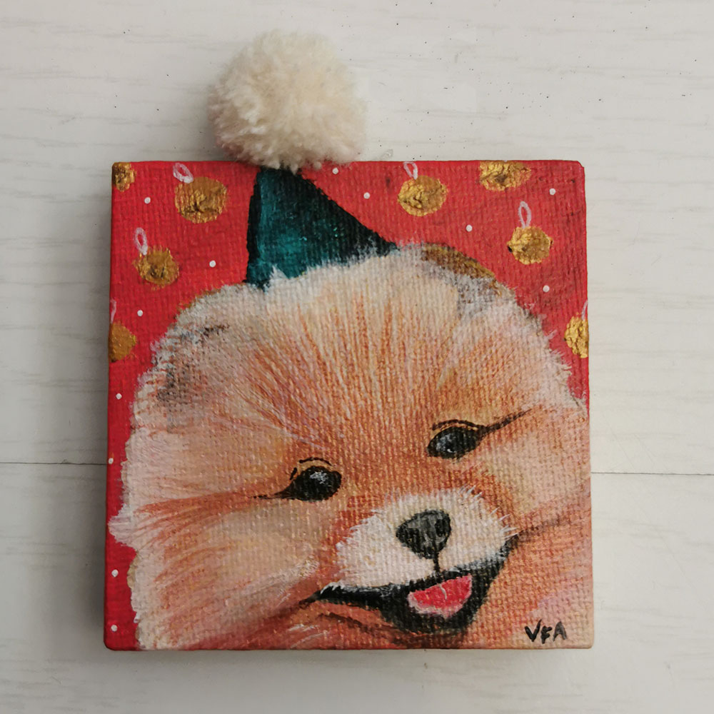 Loulou de poméranie, mini tableau aimantée sur fond rouge avec grelot et bonnet de Noël. bien touffu